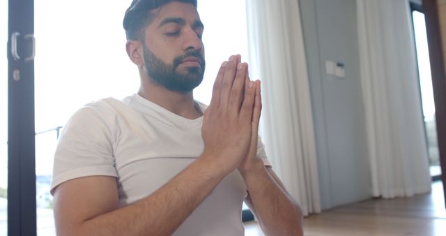 Man Practicing Meditation with Eyes Closed Indoors - Download Free Stock Images Pikwizard.com