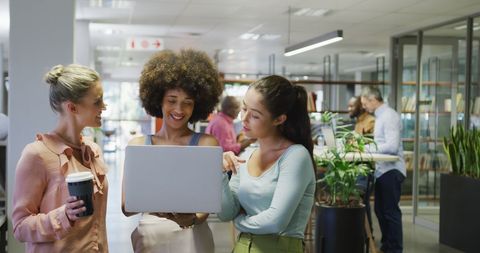 Diverse female business colleagues collaborating in modern office