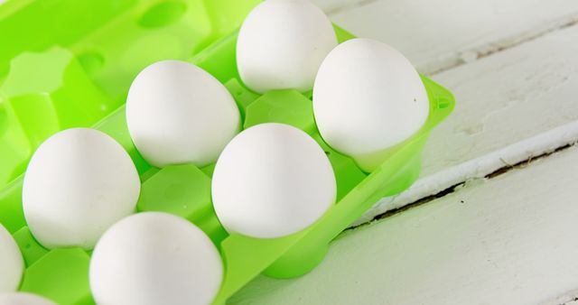 Close-Up of White Eggs in Green Egg Carton on Wooden Surface - Download Free Stock Images Pikwizard.com