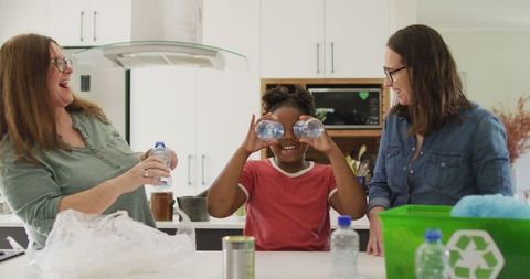 Happy Family Sorting Recyclable Waste in Kitchen