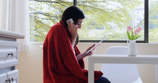 Woman in Red Sweater Talking on Phone and Using Tablet in Modern Home - Download Free Stock Images Pikwizard.com