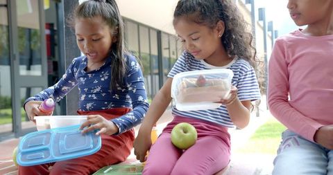 Children enjoying healthy lunch break outdoors
