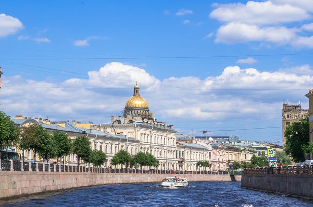 Depicting the picturesque scene of Saint Petersburg’s canal with a golden dome building in the background, this image captures the charm of the city’s waterways and architecture. Ideal for use in travel guides, tourism marketing, websites focusing on history or architecture, or promotional materials celebrating cultural heritage. The bright sky and clear waters evoke serenity, making it suitable as a decorative piece for offices and homes.