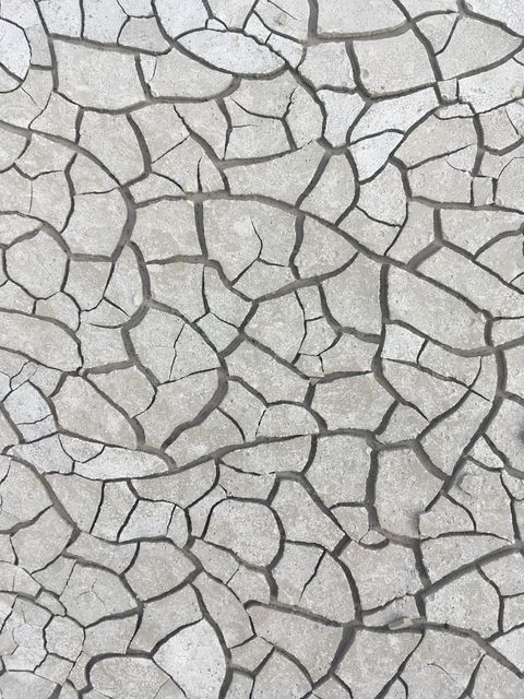 This detailed close-up of a cracked stone wall with abstract patterns is ideal for use in architecture, design, geological studies, and nature-related projects. Perfect for backgrounds, text overlays, web design, and illustrating topics on erosion or environmental changes.