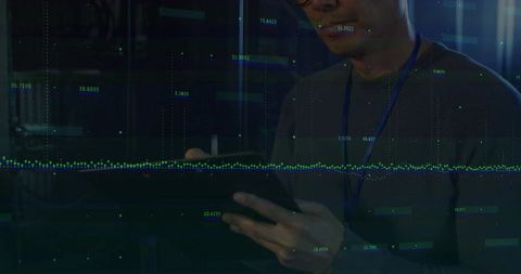 IT Professional Analyzing Data on Tablet in Server Room