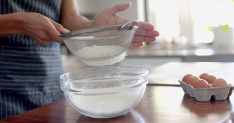 Woman Sieving Flour in Kitchen for Baking - Download Free Stock Images Pikwizard.com