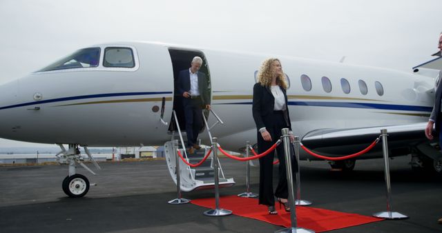 Business people leaving private jet at terminal 4k - Download Free Stock Photos Pikwizard.com