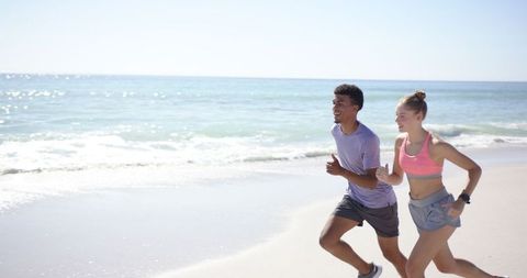 Young Couple Enjoying Beach Run on Sunny Day