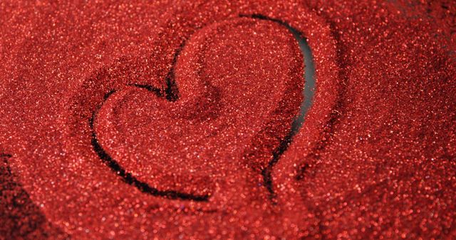 This image showcases a heart shape drawn in red glitter, creating a feeling of romance and celebration. Perfect for use in Valentine's Day promotions, romantic event invitations, and love-themed greeting cards. The sparkling texture enhances themes of passion and celebration.