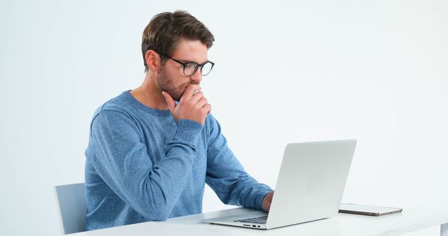 Pensive Man Wearing Glasses Working on Laptop - Download Free Stock Images Pikwizard.com