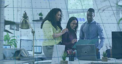 Team analyzing data with digital overlay in office