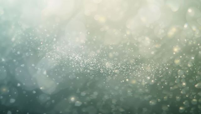 Glittering teal bokeh with floating dust particles and soft light gradient background