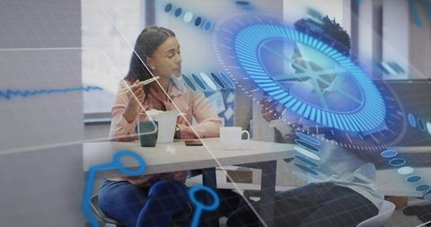 Colleagues discussing with futuristic augmented reality interface in modern office
