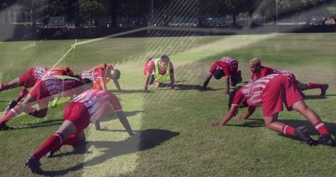 Soccer Team Stretching on Grass Field During Practice