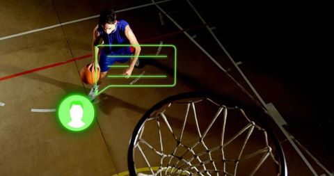 Overhead basketball player dribbling with green AR HUD on indoor court