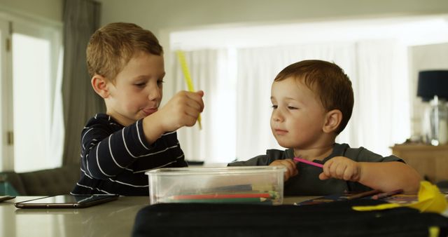 Young Brothers Engaged in Creative Play with Colored Pencils - Download Free Stock Images Pikwizard.com