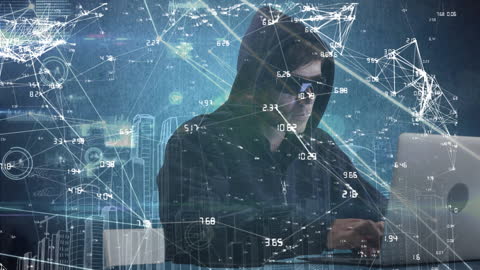 Male Hacker in Hood Using Laptop for Cybercrime