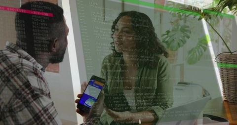 Developers collaborating with mobile app and laptop while code overlay suggests teamwork