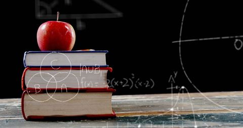 Books with Apple and Mathematical Equations on Blackboard - Download Free Stock Images Pikwizard.com