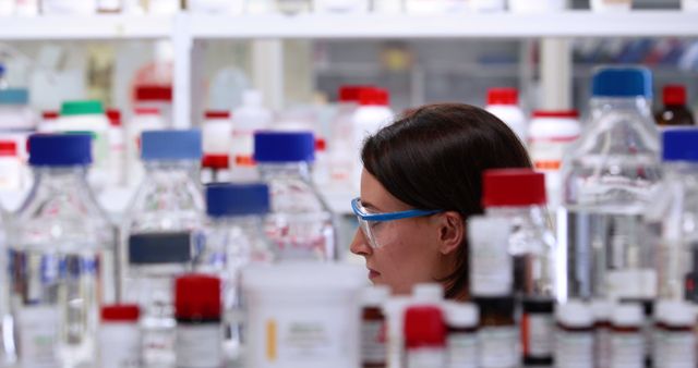 A female scientist meticulously examines lab samples, highlighting the precision of research. - Download Free Stock Photos Pikwizard.com