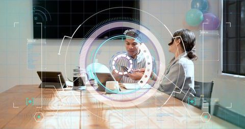Business team collaborating with augmented reality headset and prototype in modern office