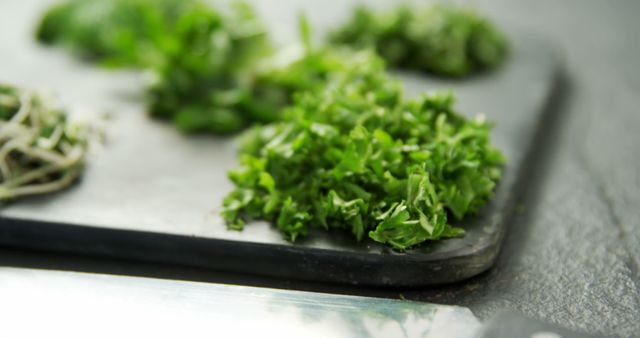 Fresh Chopped Herbs on Black Cutting Board with Knife - Download Free Stock Images Pikwizard.com