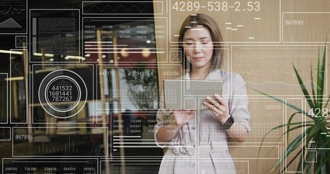 Asian Businesswoman Analyzing Digital Data on Tablet in Modern Office
