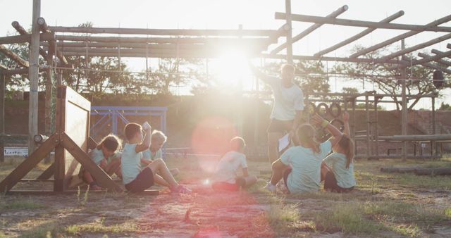 Group of Kids Resting After Outdoor Obstacle Course Training at Sunset - Download Free Stock Images Pikwizard.com