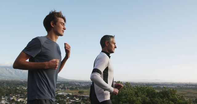 Father and Son Jogging Together Outdoors on Scenic Path - Download Free Stock Images Pikwizard.com