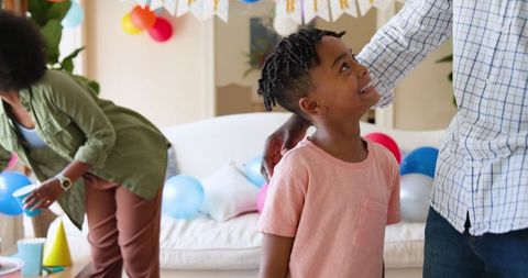 Cheerful Family Celebrating Son's Birthday with Joy at Home