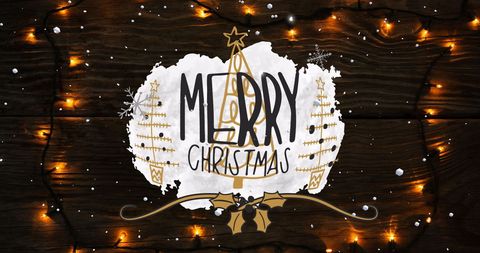 Festive Merry Christmas Text with Fairy Lights on Wooden Background