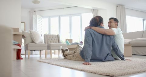Happy Couple Embracing in New Home Living Room Filled with Joy