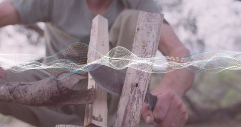 Man Carving Wood with Knife Outdoors in Orchard