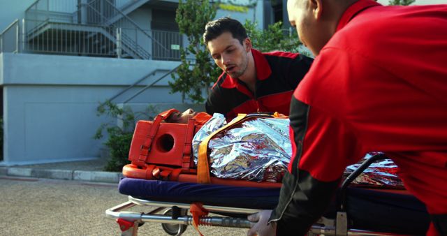 Emergency responders transporting accident victim on stretcher - Download Free Stock Images Pikwizard.com