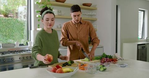Couple Preparing Fresh Vegetables at Modern Kitchen Counter