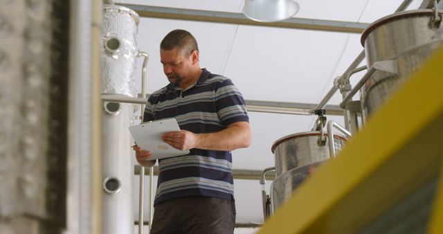 Brewery Worker Conducting Inspection of Equipment - Download Free Stock Images Pikwizard.com