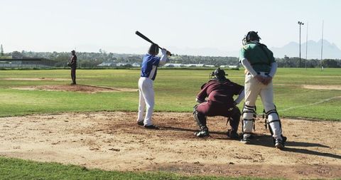 Baseball Players and Umpire on Scenic Outdoor Field
