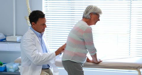 Doctor Assessing Senior Patient's Back in Medical Office - Download Free Stock Images Pikwizard.com