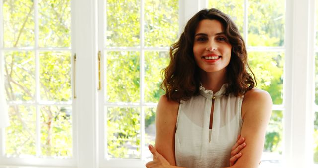 Confident Young Woman Standing by Bright Window in Summer - Download Free Stock Images Pikwizard.com