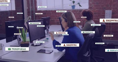 Customer support agents verifying incoming user ids and call data on office monitors