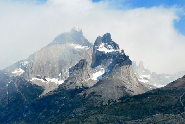 Majestic Snow-Capped Mountain Peaks with Misty Clouds - Download Free Stock Photos Pikwizard.com