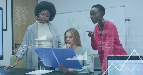 Three Business Women Collaborating Over Data Folder and Analytics During Office Meeting