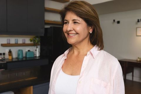 Charming Hispanic Woman in Cozy Modern Kitchen Smiling