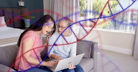 Adult daughter teaching senior chinese mother laptop skills on sofa with dna overlay