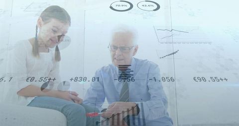 Grandfather teaching granddaughter with charts and financial data