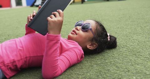 Young Girl with Tablet in Outdoor Learning Environment