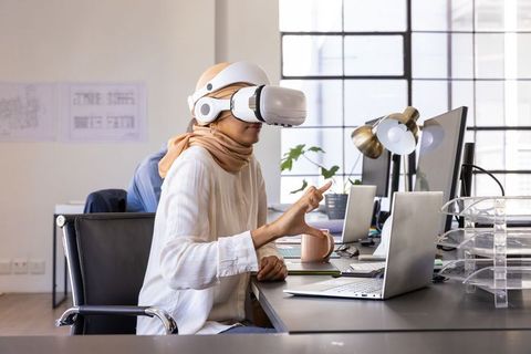 Young Woman Using VR Headset in Modern Office Setting
