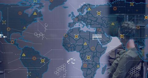 Analyst Reviewing Global Network Map with Futuristic Data Visualization
