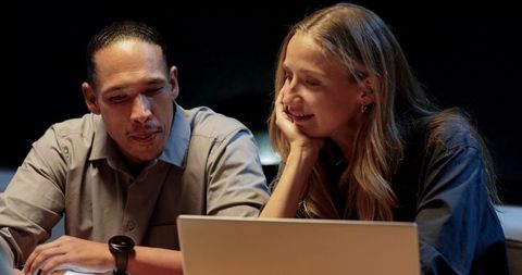 Colleagues brainstorming during late-night meeting
