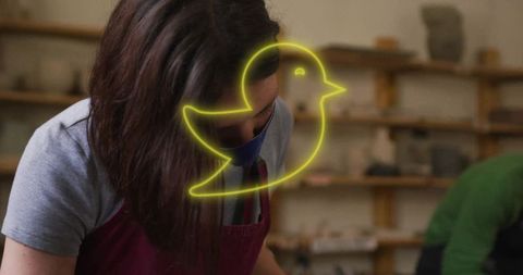 Female potter shaping clay in artisan studio setting